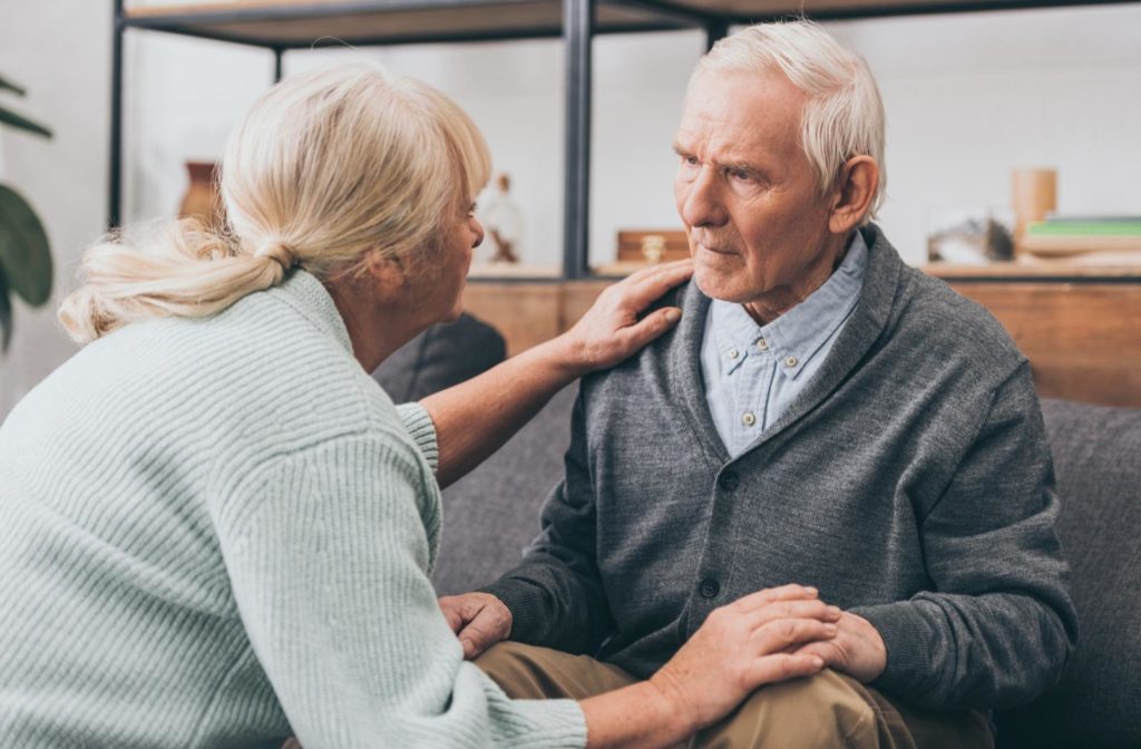 Senior woman looking at her husband with worry because of his dementia