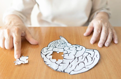 An image of a brain puzzle, with a piece taken out to symbolize dementia.
