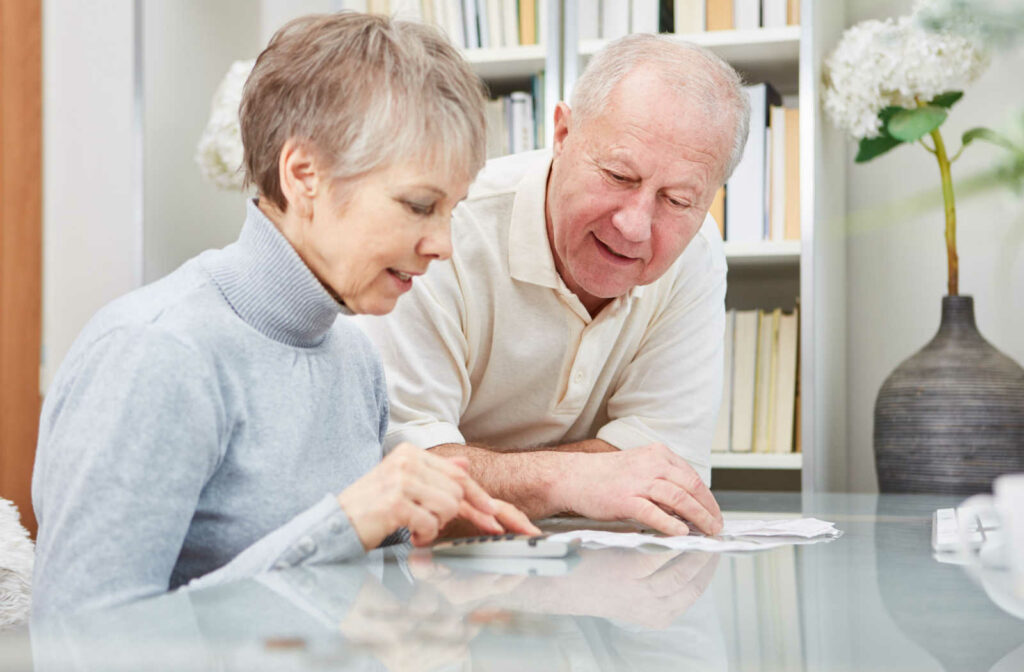 A senior couple smiling after submitting their finances.