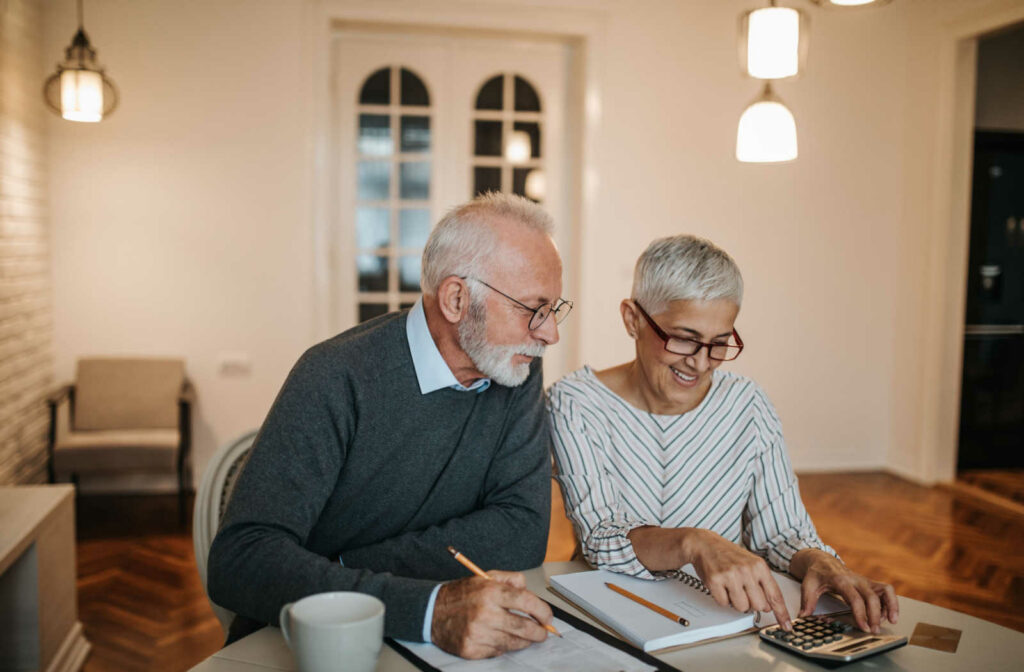 A senior couple doing their taxes on a laptop.