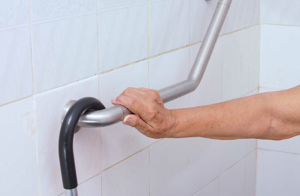 Image of a mature adult's hand holding a grab bar.