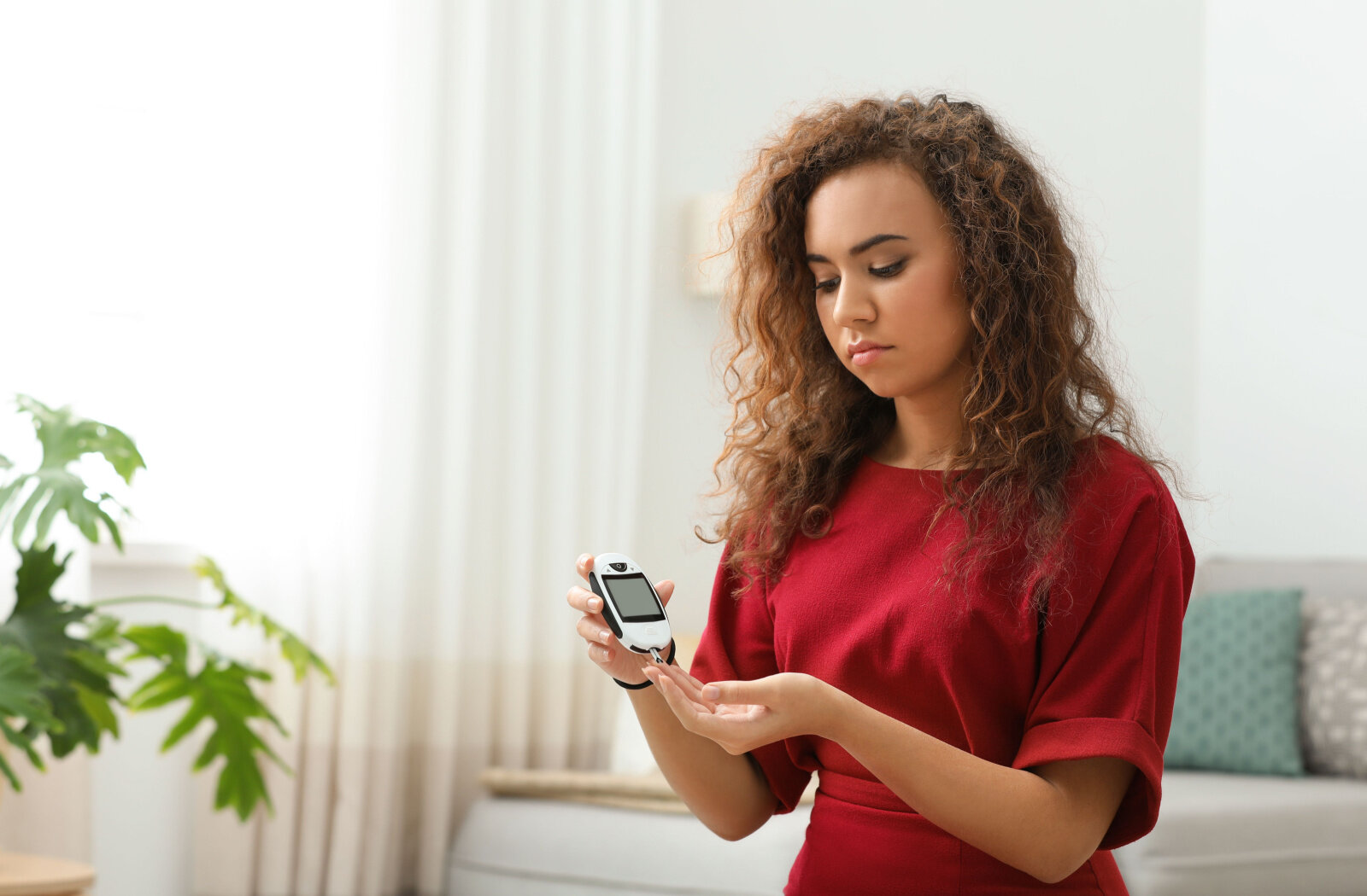 Young woman testing her blood sugar level. 