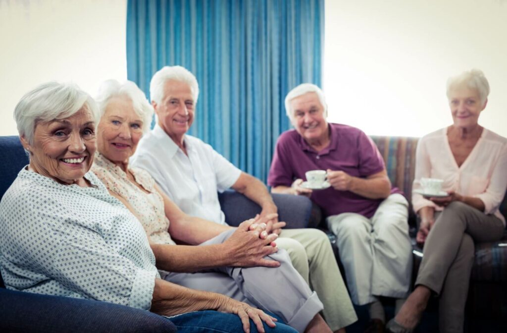 A group of seniors in independent living socialize in a common space, delighting in each other’s company