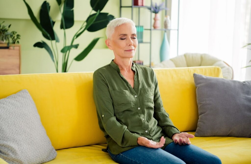 senior woman sitting on a yellow sofa and enjoying her personalized space
