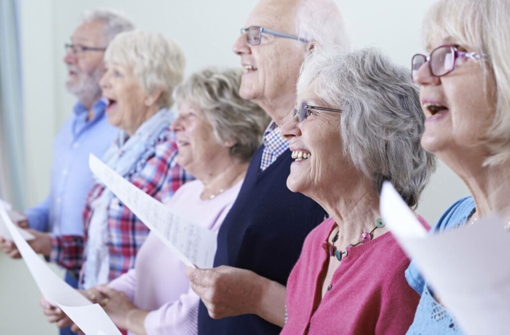A group of seniors sing together in a music class.