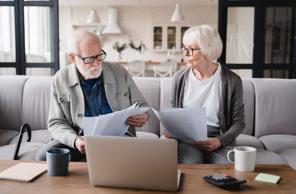 A senior couple browse through brochures from a senior living community that they recently visited.
