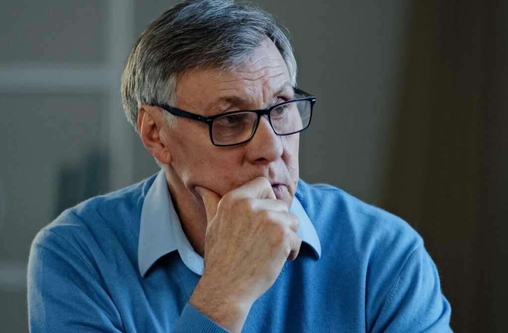 Close up of a concerned senior resting their head on their hand