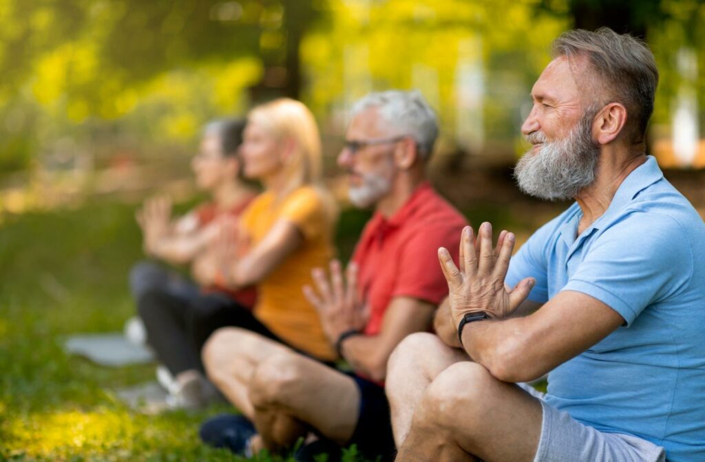 seniors doing yoga in a park