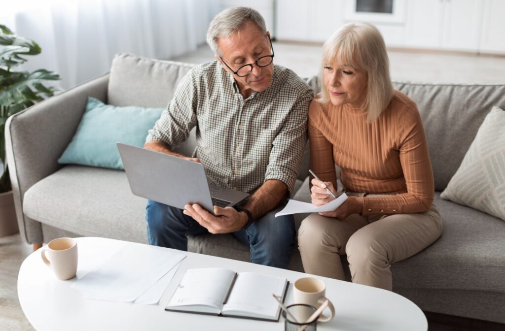 A senior couple note important belongings to pack for their upcoming move to independent living